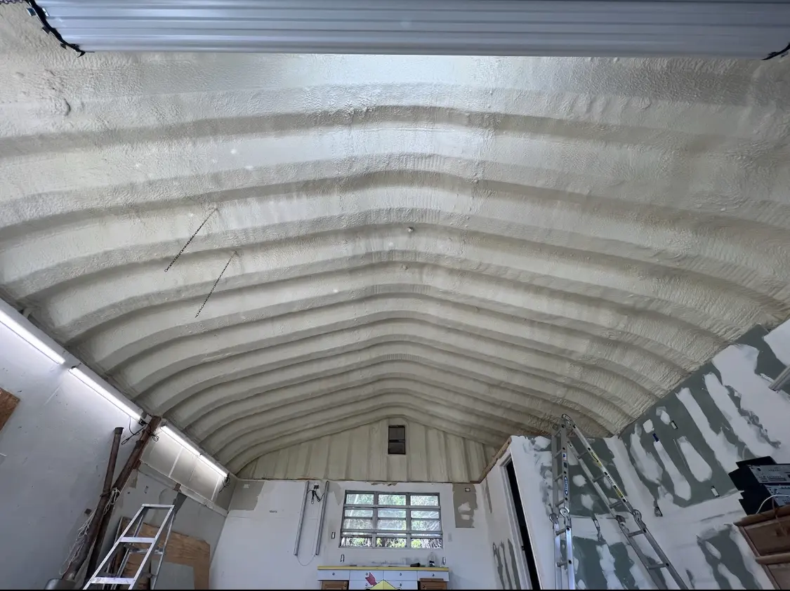 Spray polyurethane foam applied to the underside of a metal roof deck in Sidney